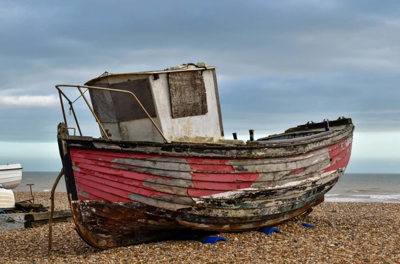 a red and white boat on the beach