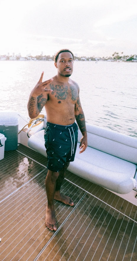 a man posing on a boat in a body of water