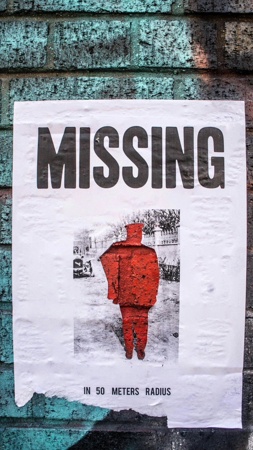 a paper sign with an image of a red man wearing a red suit and missing sign