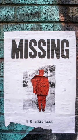 a paper sign with an image of a red man wearing a red suit and missing sign