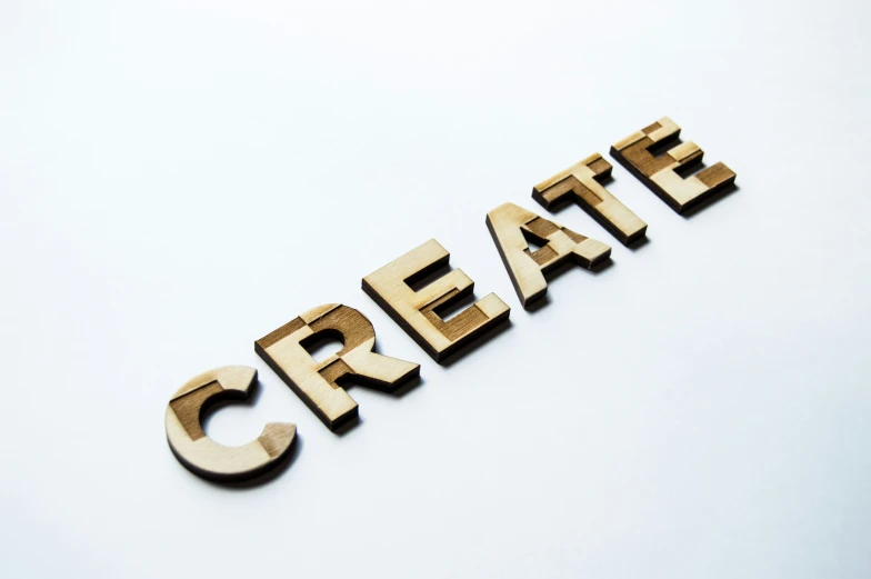 the word create spelled in wood type