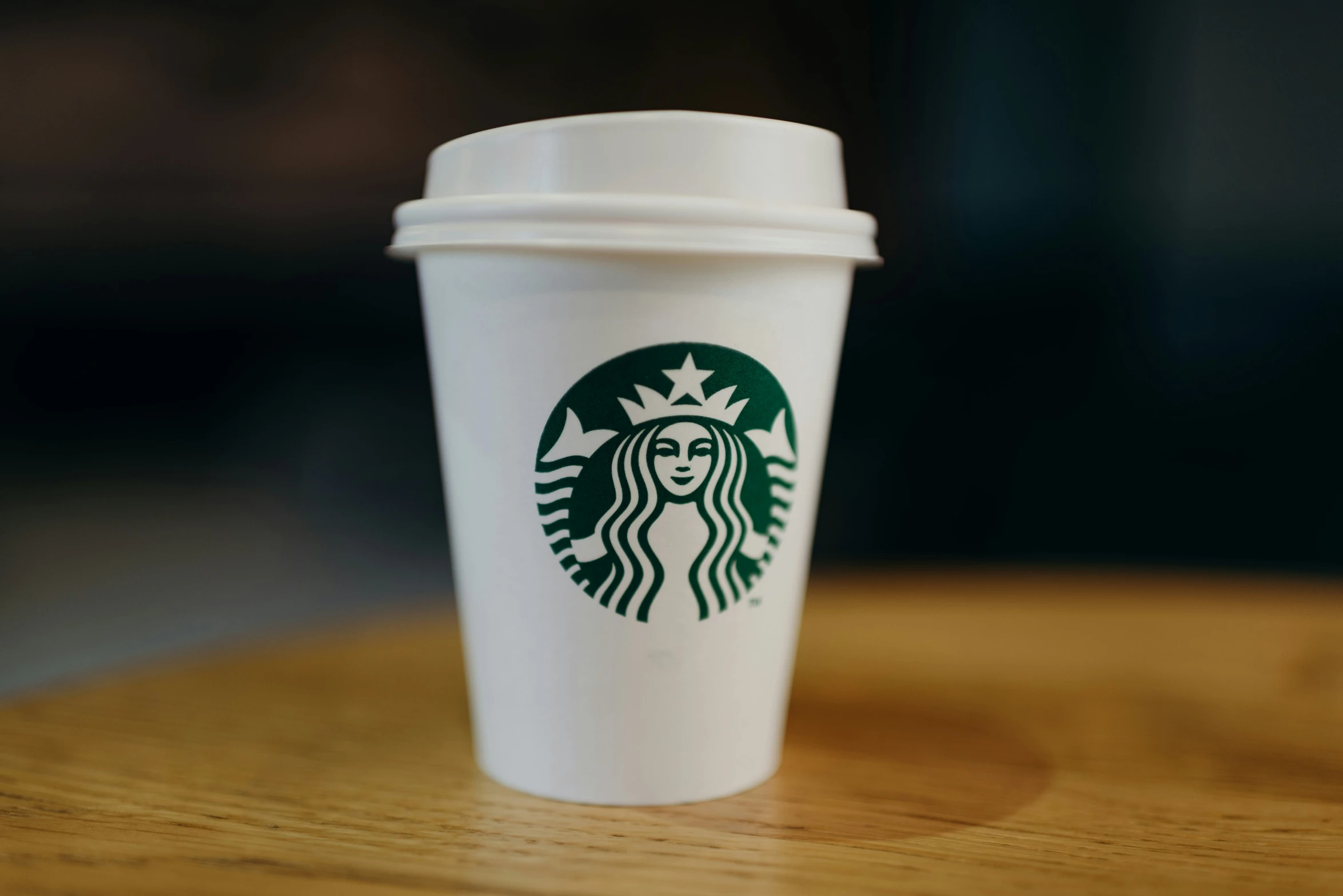 a coffee cup with the logo of starbucks
