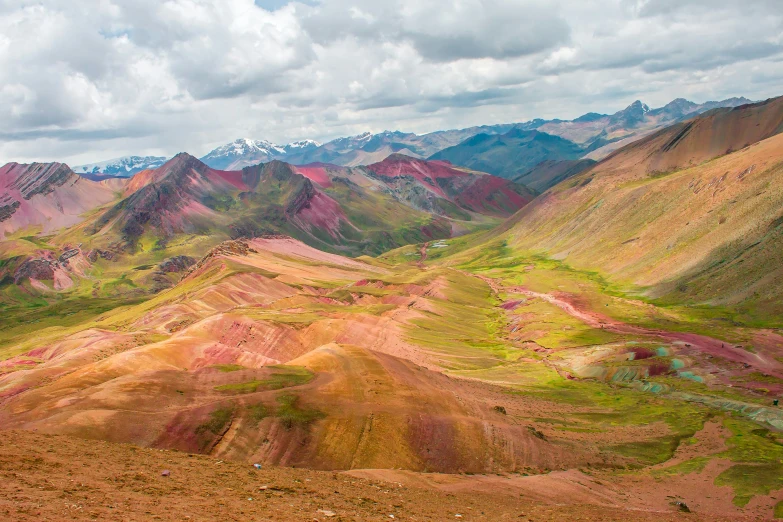 a mountain with many colored rocks and valleys