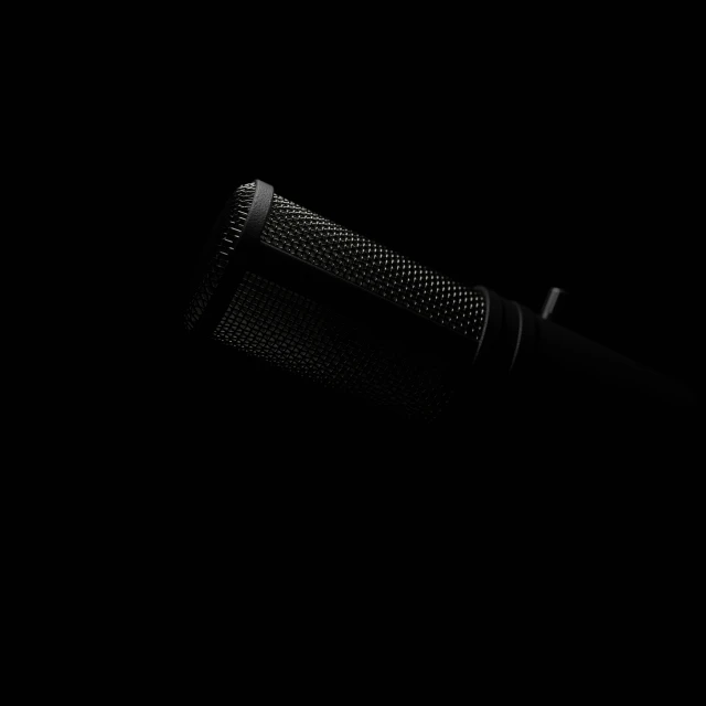a black background with a microphone and some sort of device