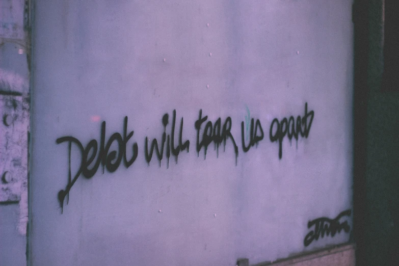 graffiti written on the wall near a clock