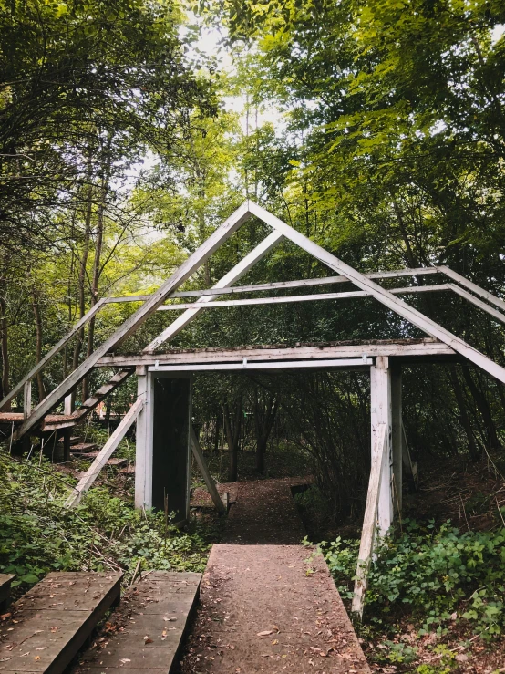 a structure in the middle of a forest