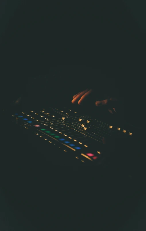 an illuminated keyboard being operated by one hand