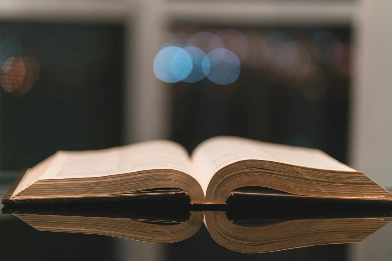 an open book on a glass table top