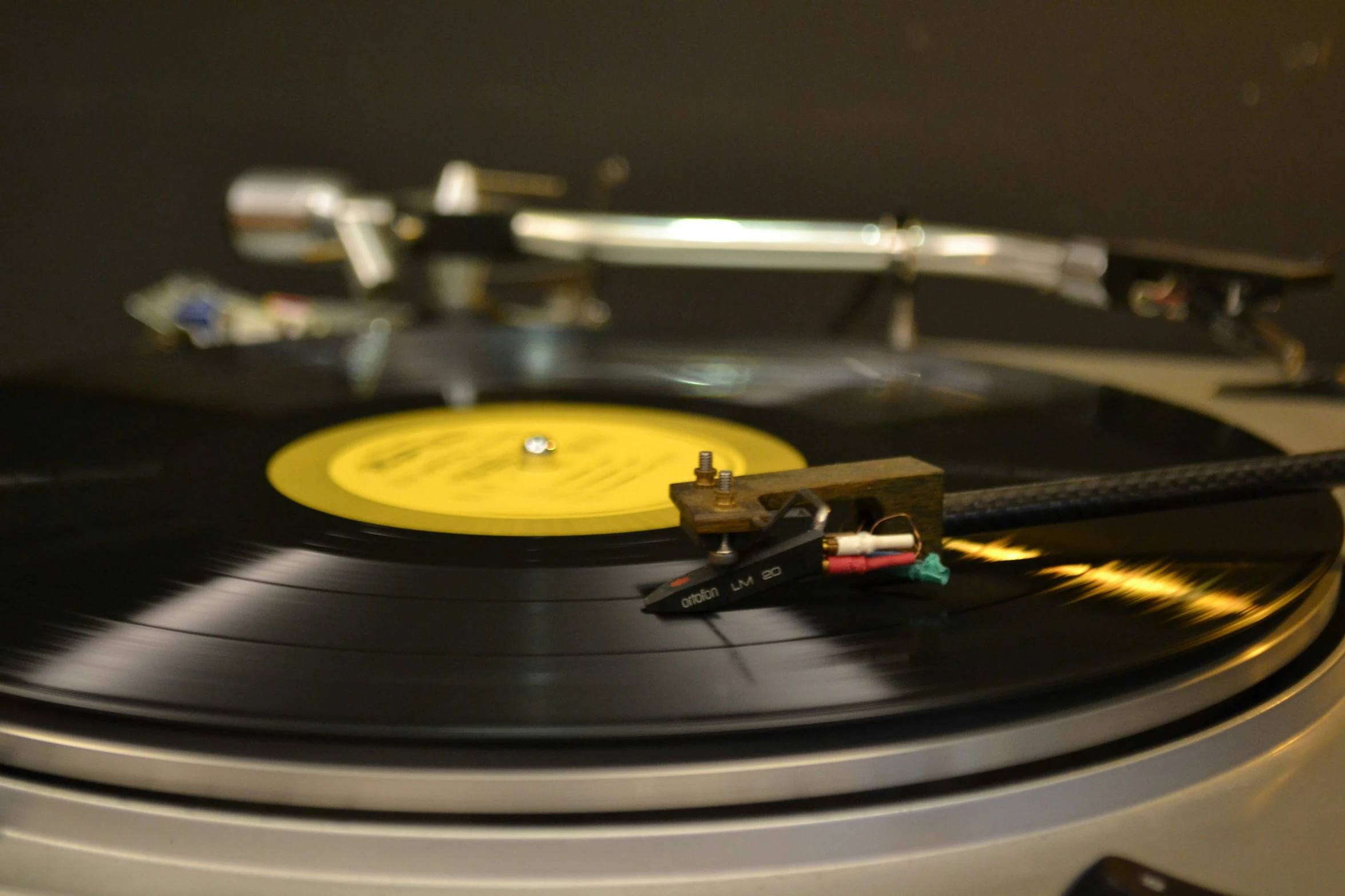 a record player with an antique vinyl player in background