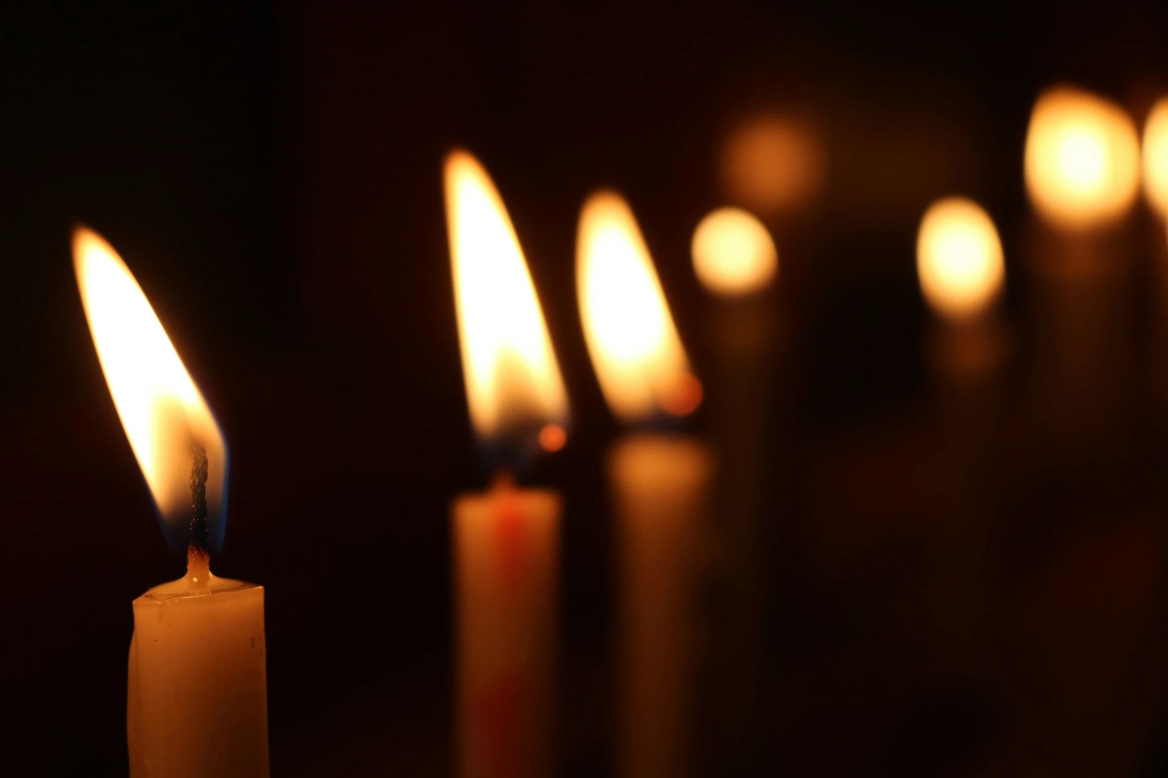 a group of candles lit with different candles