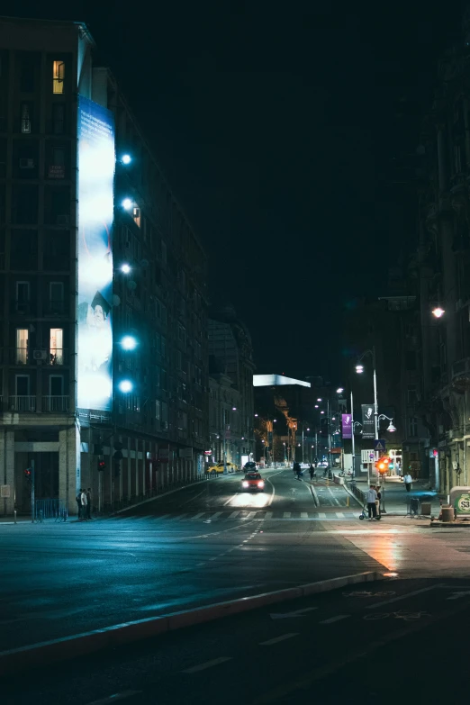 a car driving down the road at night time