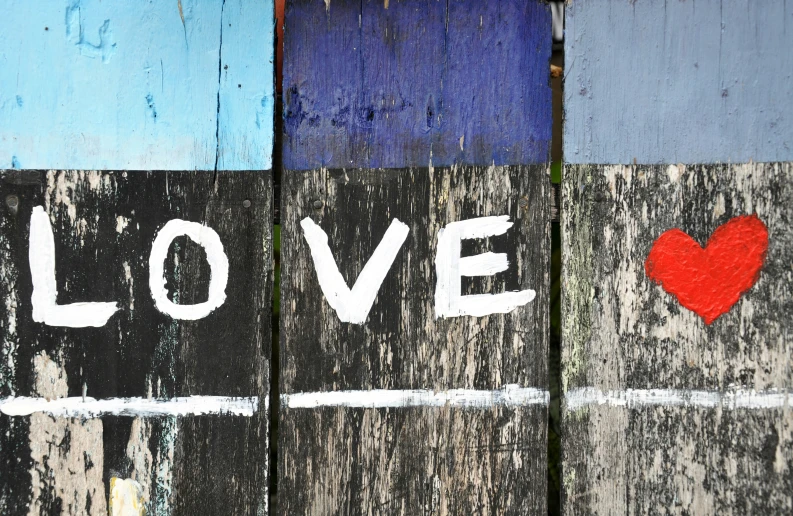 painted wood with the words love and a red heart