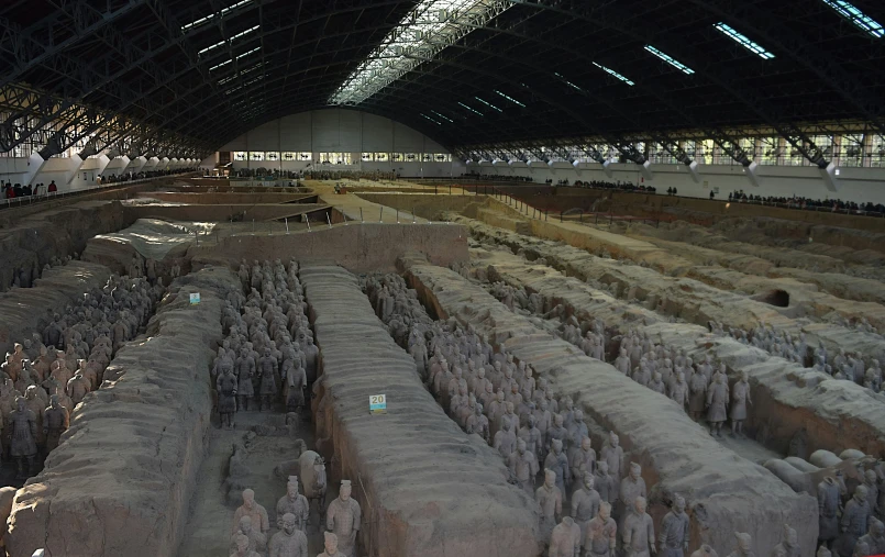 a room full of people in stone statues