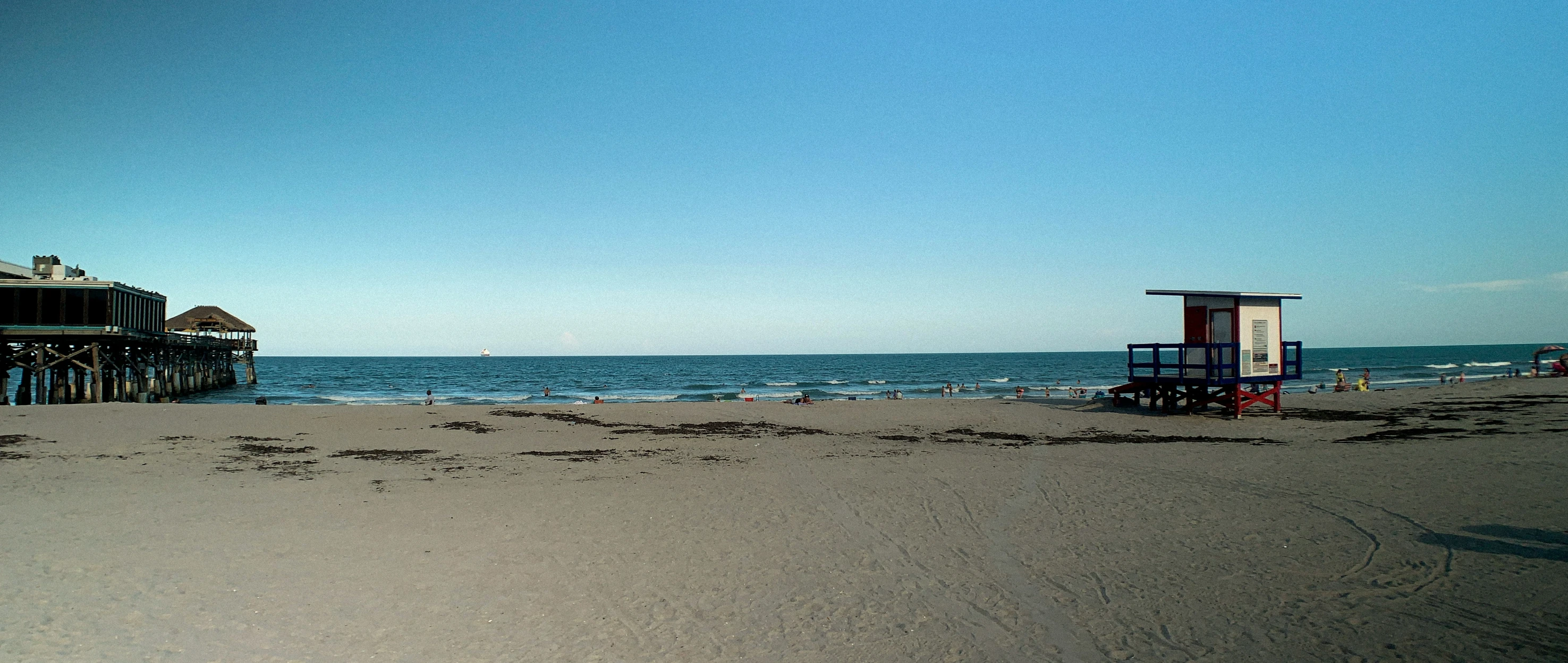 several lifeguard huts at the beach during the day