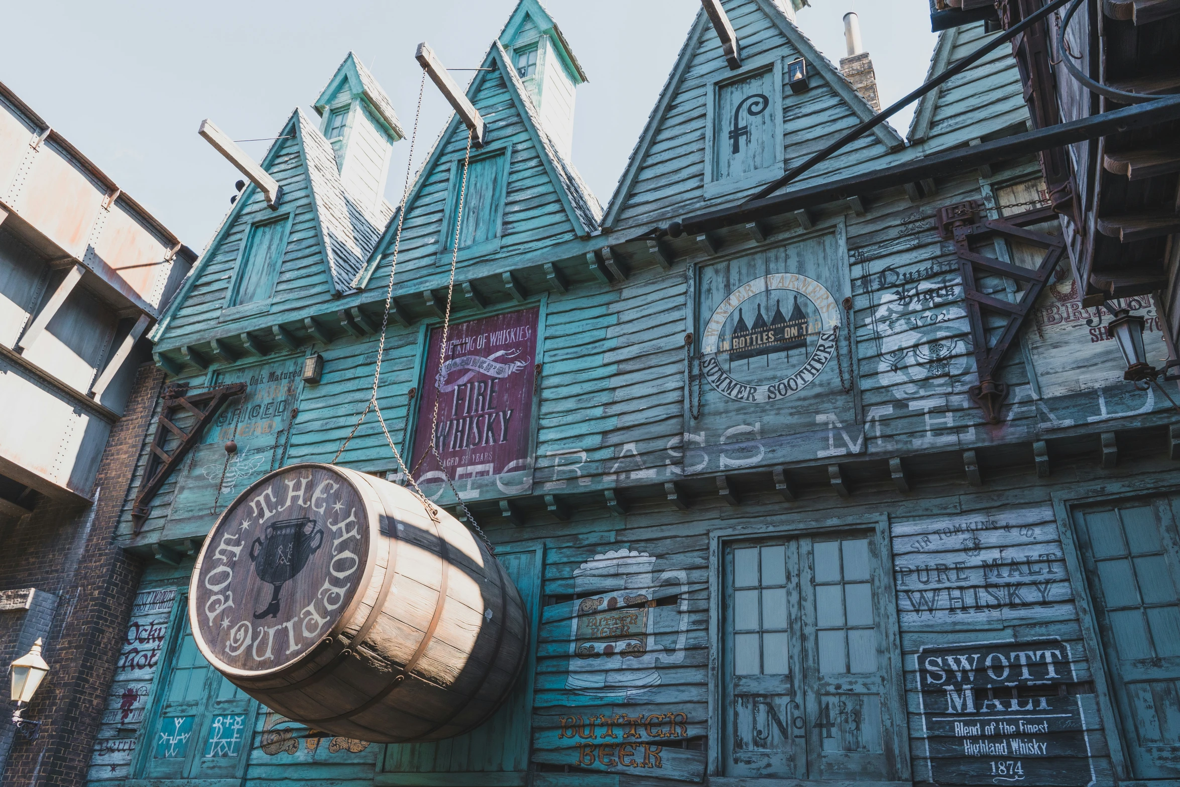 some old fashioned buildings and a big clock on a pole