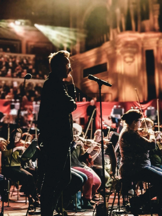 a conductor with microphone performing a musical performance