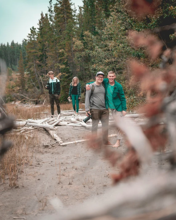 a group of people walking across a dirt road