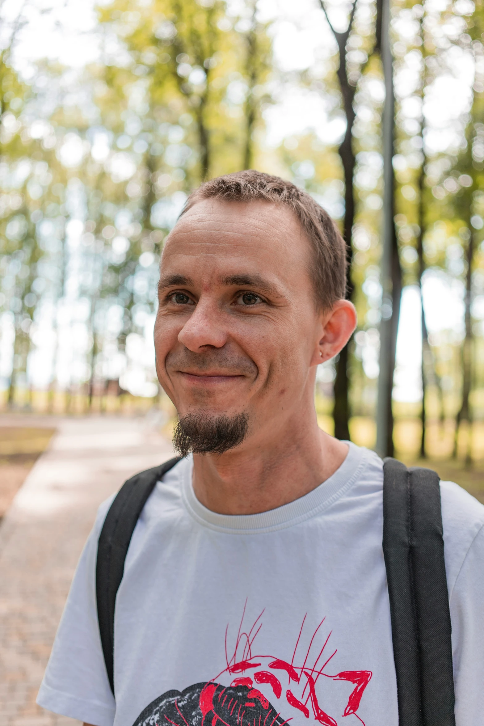 a smiling man is wearing a red helmet