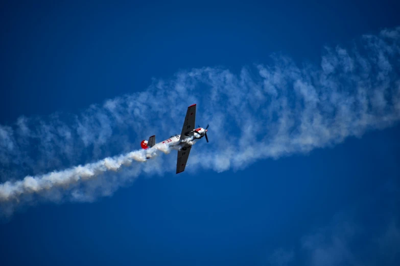 the airplane has smoke coming from its back end