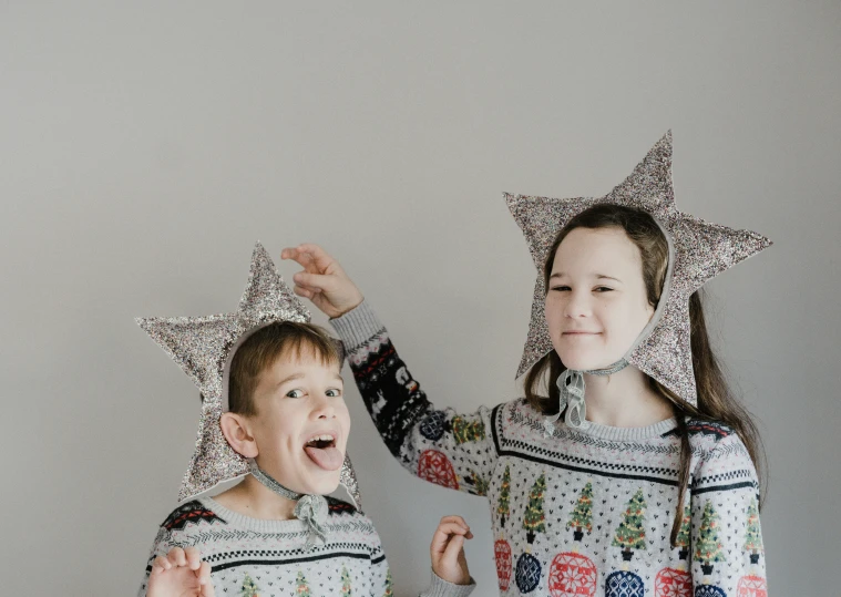 two young children wearing christmas stars, one in pajamas
