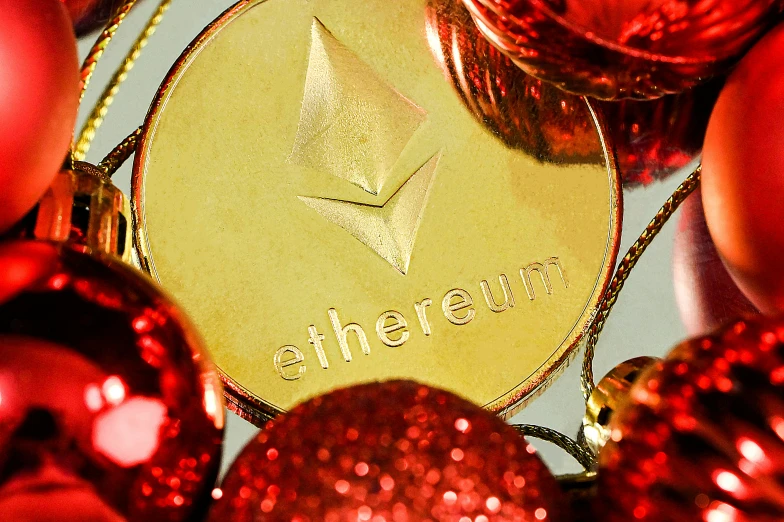 a gold one pound coin surrounded by christmas balls and baubbles