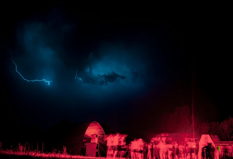 people gather under dark skies during nighttime