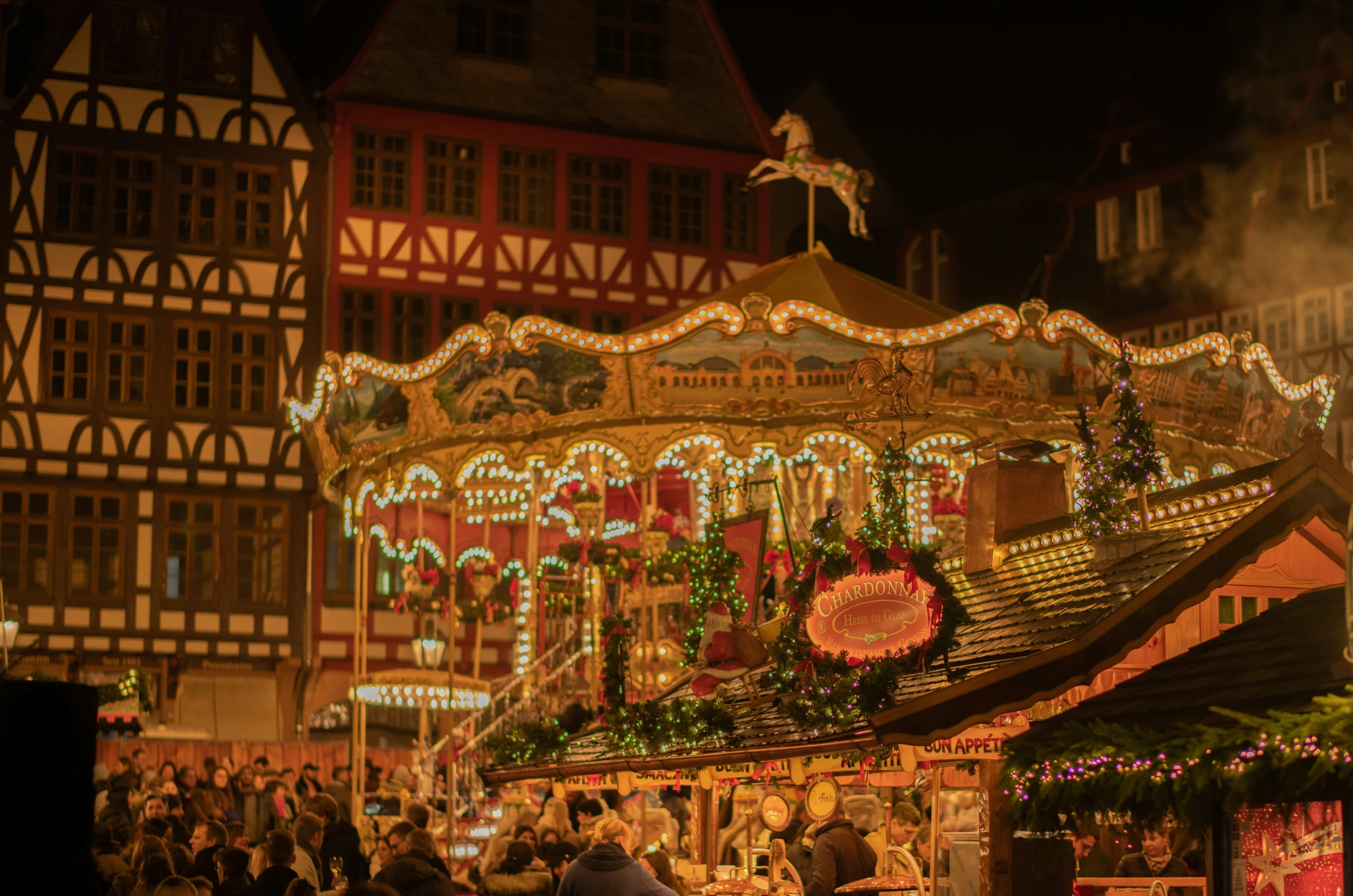 a christmas decorated carousel in a city street