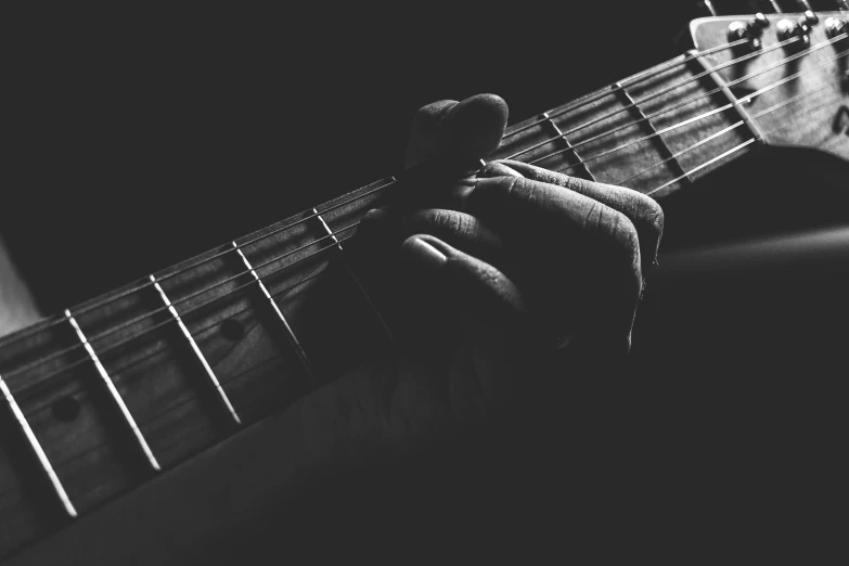 a man with his hand on a guitar