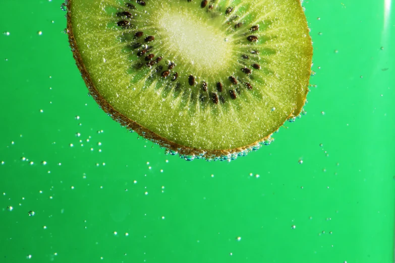 a kiwi is sliced with little dots on the bottom