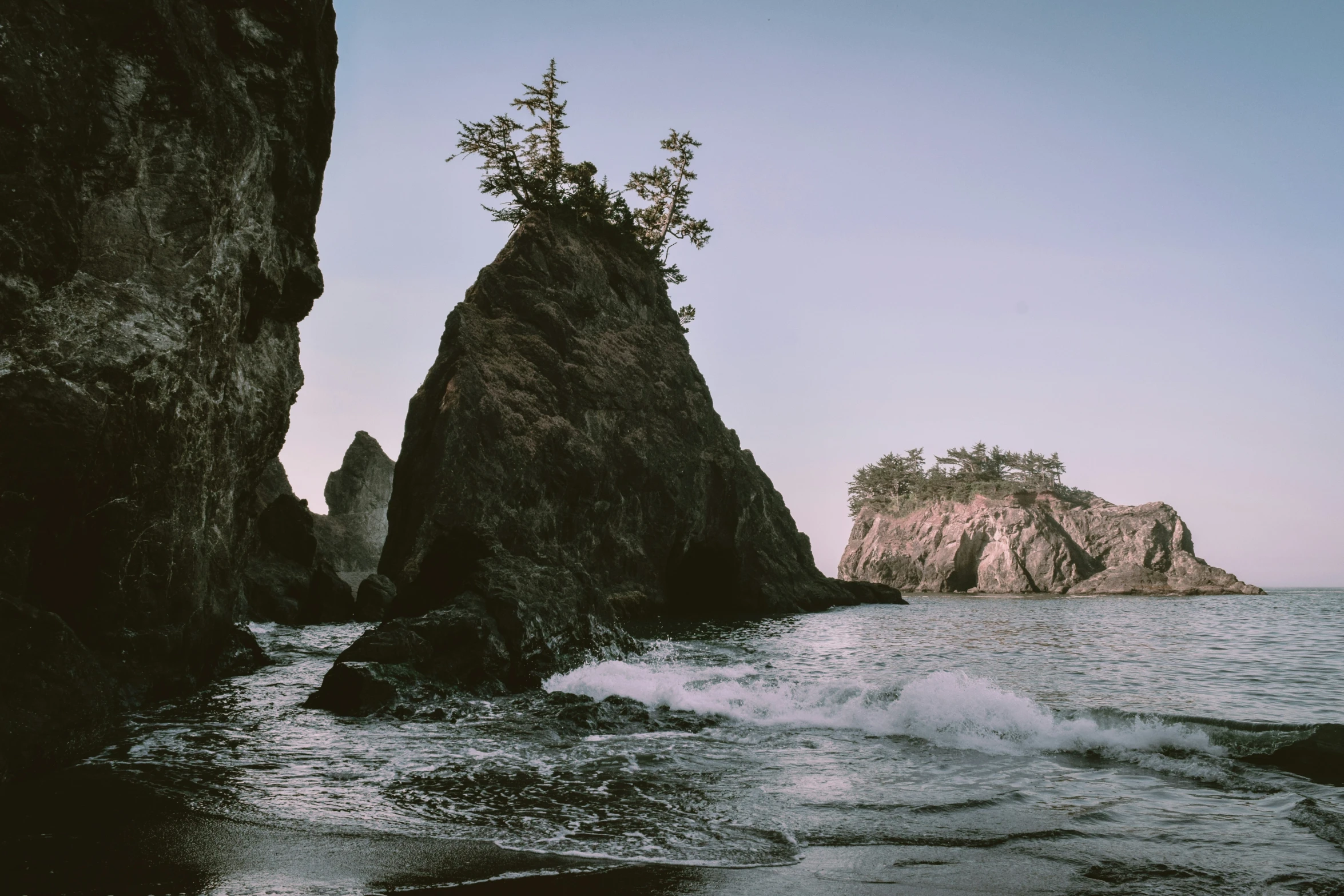 a beach area with an island near water