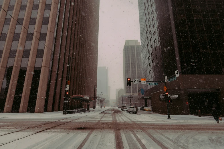 the streets are covered in snow as traffic lights glow