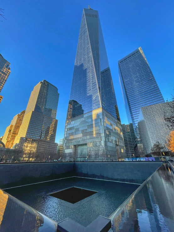 a large pool and tall buildings in a city