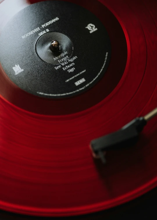 an old record player with red vinyl on the side