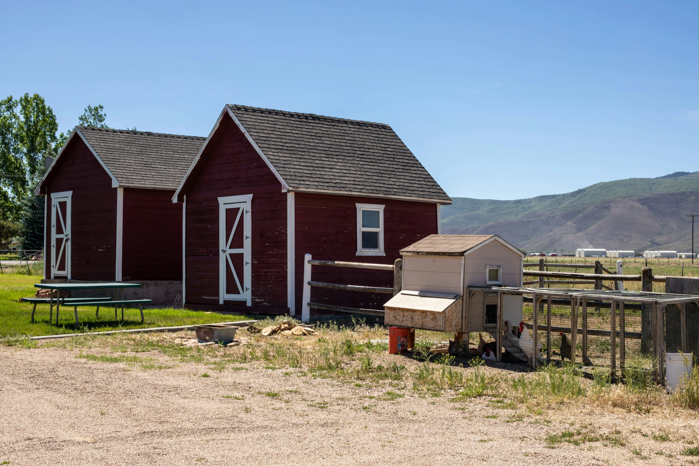 small red house with a chicken coop at the base