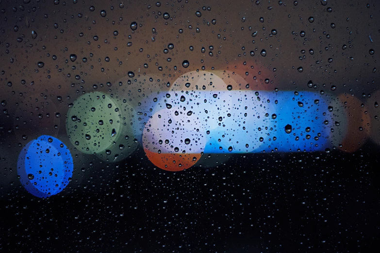 two bright round lights seen through the rain