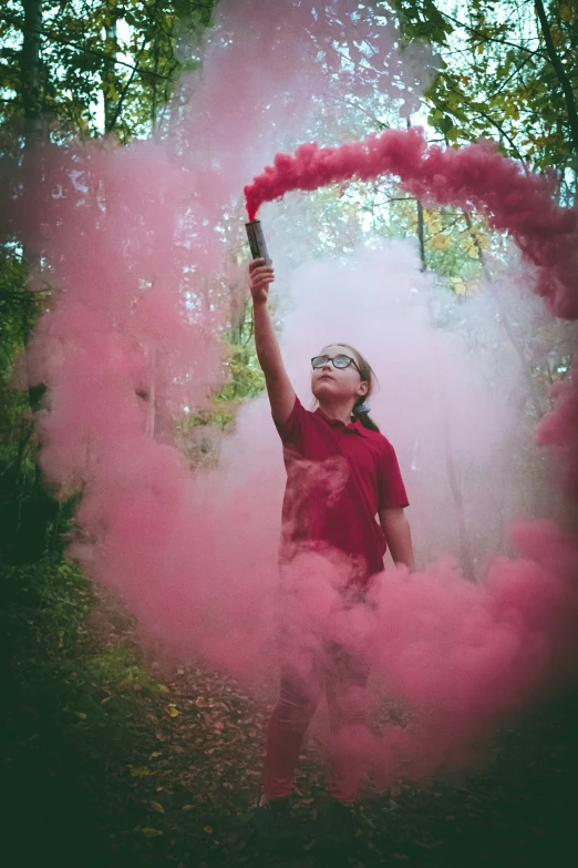 a person throws pink powder onto the ground