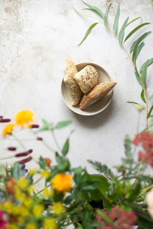 a bowl with some food on it near flowers