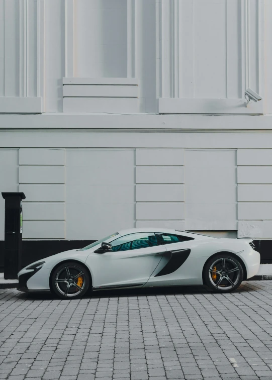 a sports car that is sitting on the side of a building