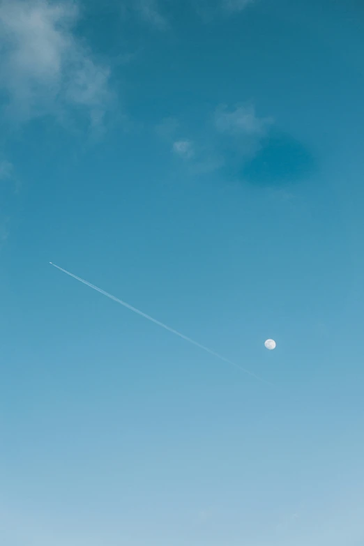 a plane flying through a bright blue sky