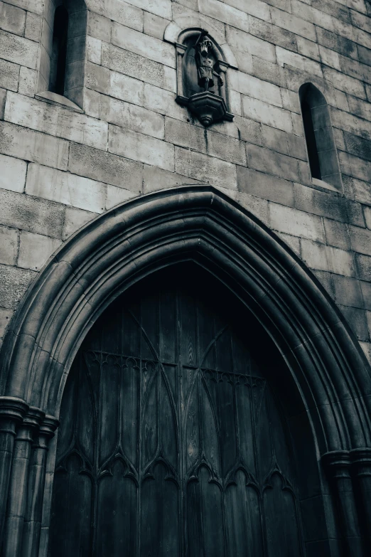 an old church door is surrounded by gothic gothic windows