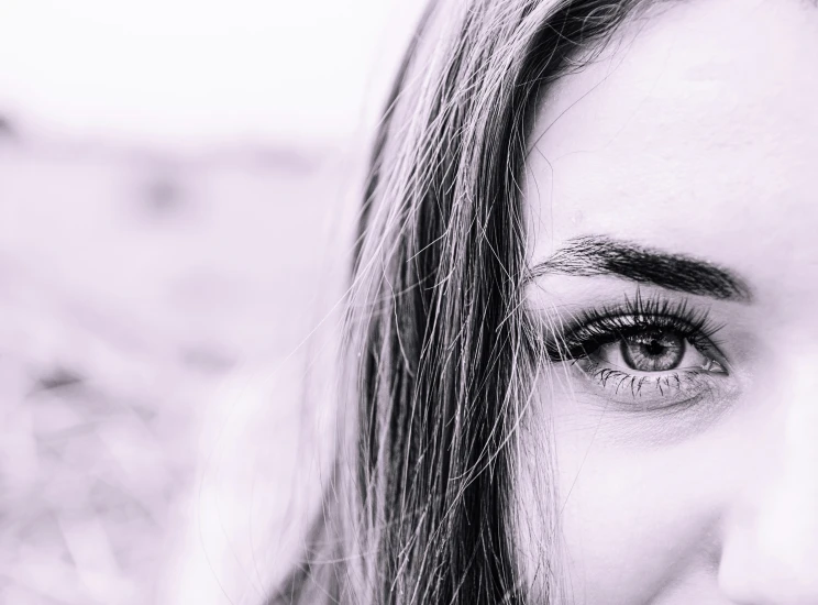 a woman with long hair and blue eyes