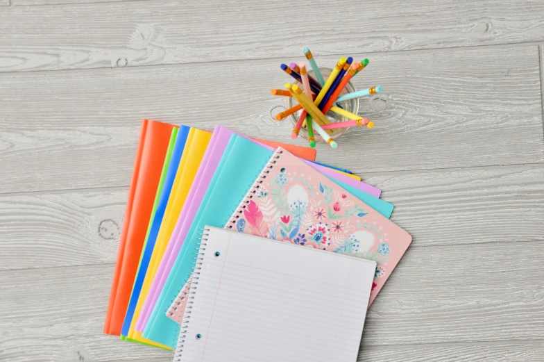 a white wooden table has stationery items on it