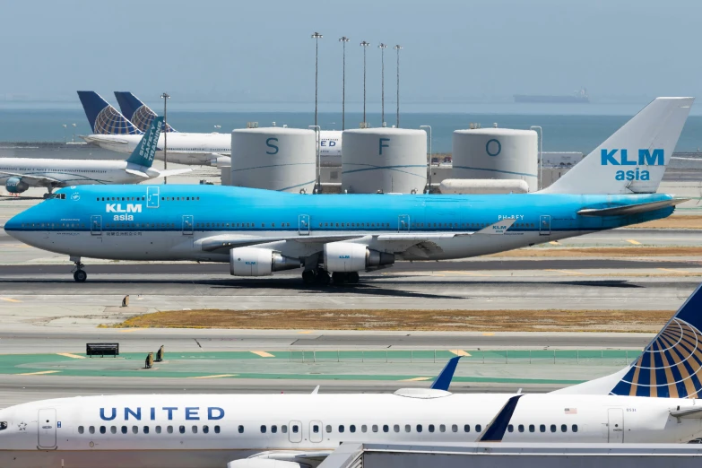 an airport with many jumbo jetliners parked in front