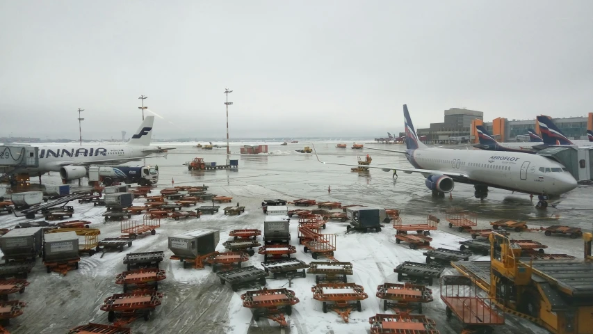 there are two planes at the airport on the runway