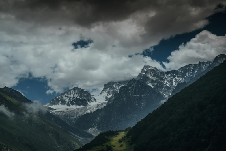 a few mountains are in the distance under a cloudy sky