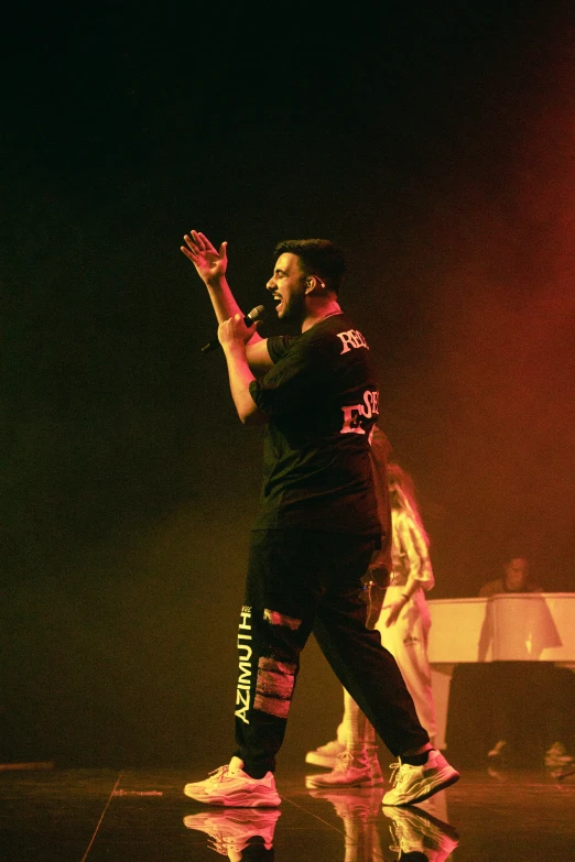 male dancer in black performing on stage during a show