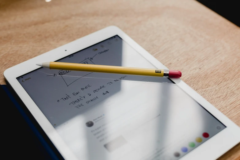 a small pencil sticking out of an ipad with its case