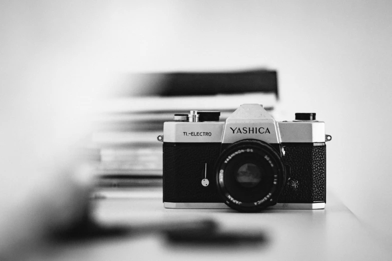 a camera sitting on top of a table next to a chair