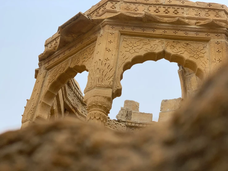 an old ornate structure with an arch between it