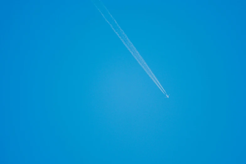 the jet is flying high in the clear blue sky
